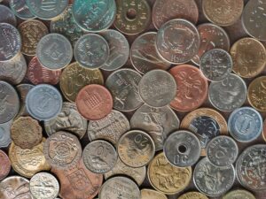Close-up of silver and gold coins in a pile, representing leftover currency.