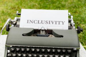 Vintage typewriter with a paper sheet displaying the word “inclusivity.”